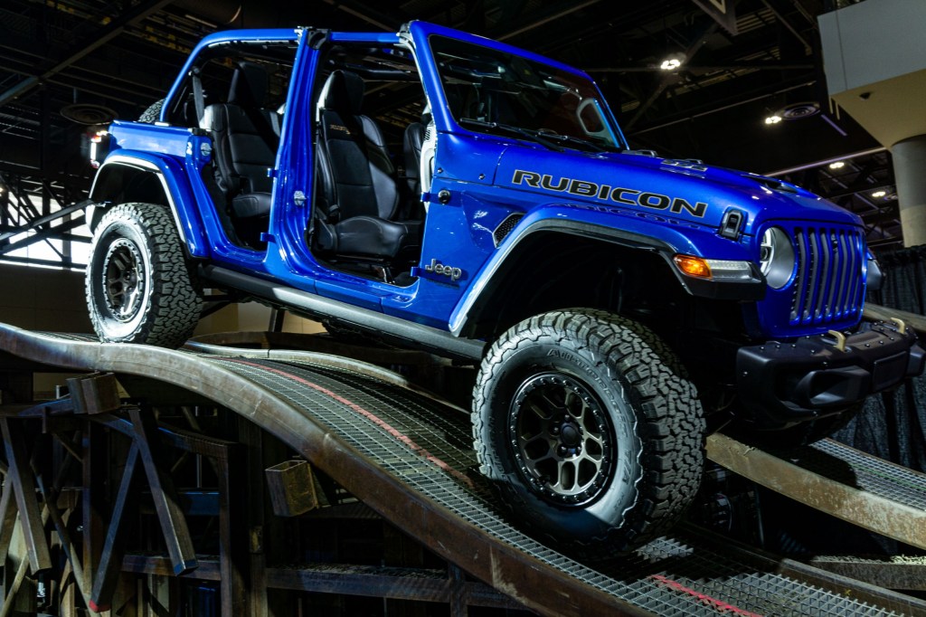 A blue 2021 Jeep Wrangler Rubicon 392 Xtreme Recon parked on a ramp heading down