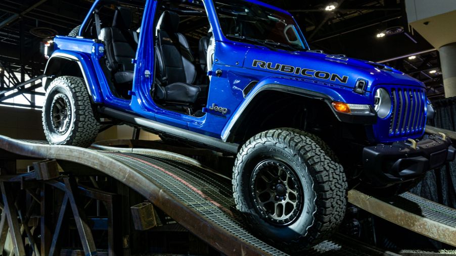 A blue 2021 Jeep Wrangler Rubicon 392 Xtreme Recon parked on a ramp heading down