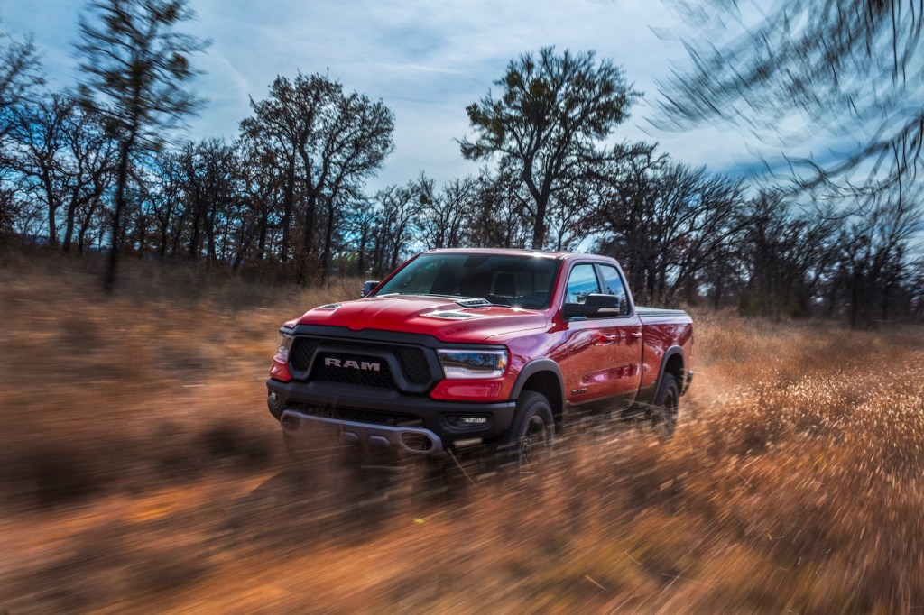 A red 2021 Ram 1500 driving through the dirt, the 2021 Ram 1500 is one of the best 4WD trucks of 2021