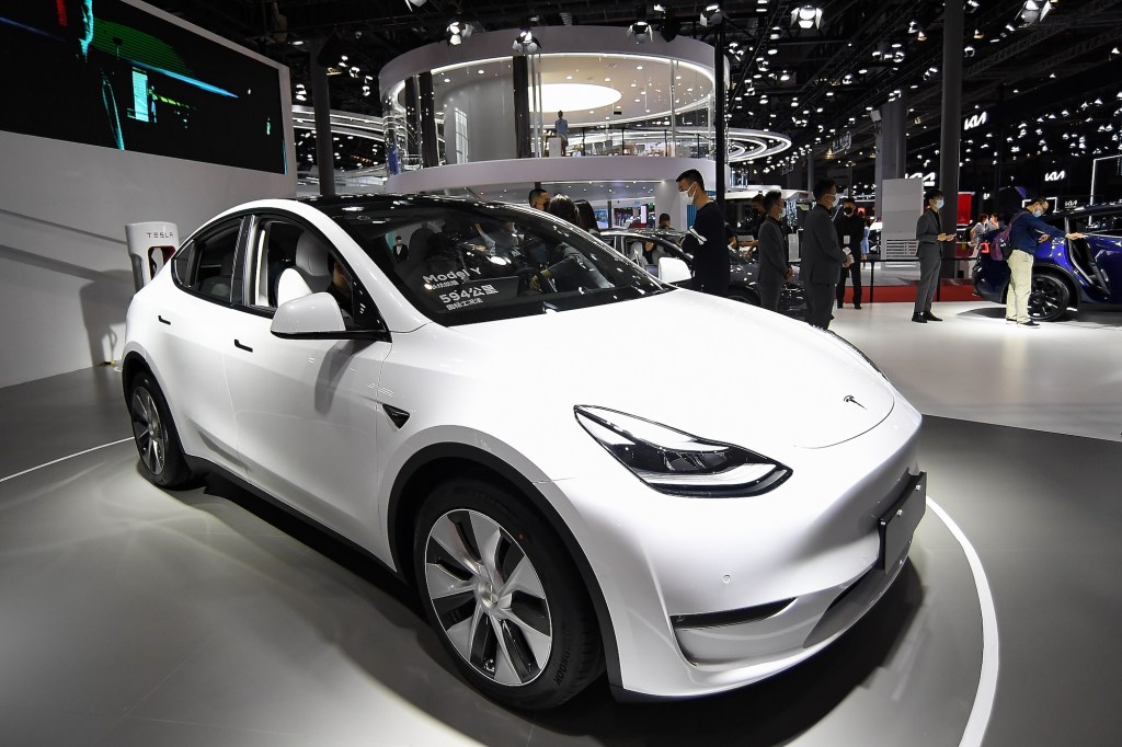 A white 2021 Tesla Model Y electric crossover SUV on display at Auto Shanghai 2021