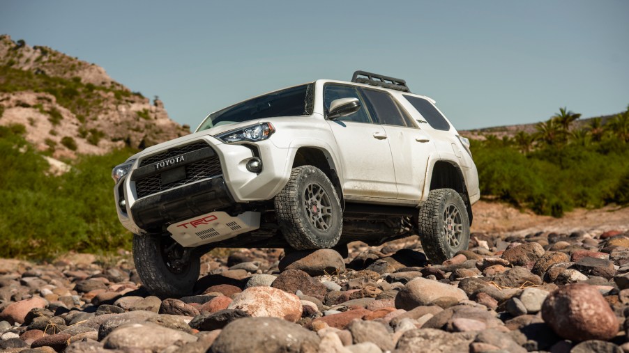 A white 2021 Toyota 4Runner TRD Pro crawling over rocks