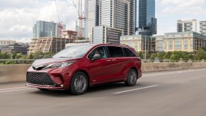 Red 2021 Toyota Sienna Driving Down The Highway