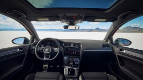 The black interior of a 2021 Volkswagen Golf GTI hatchback parked in a desert