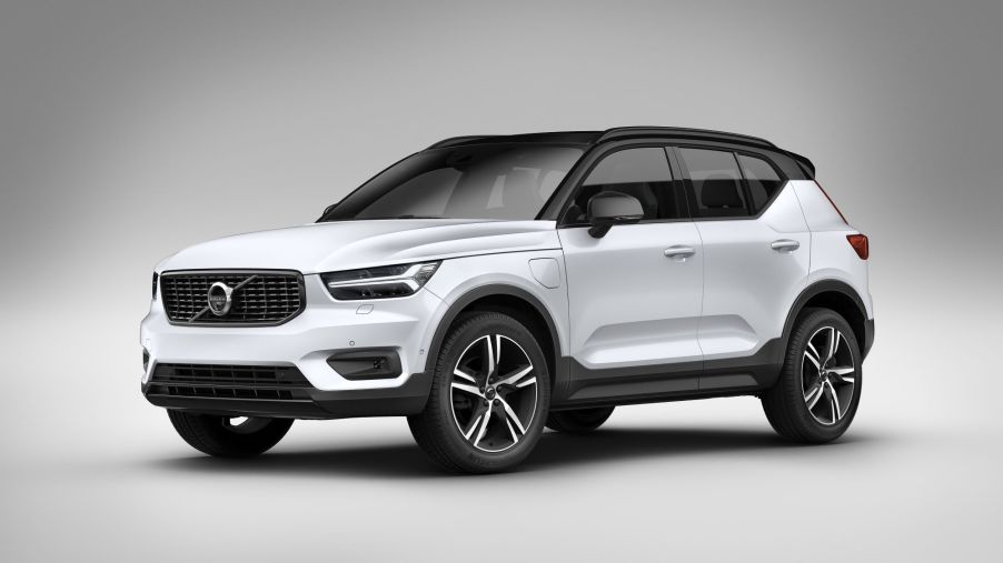 A white 2021 Volvo XC40 in front of a cream background and ground with a black vignette on the outside edges.