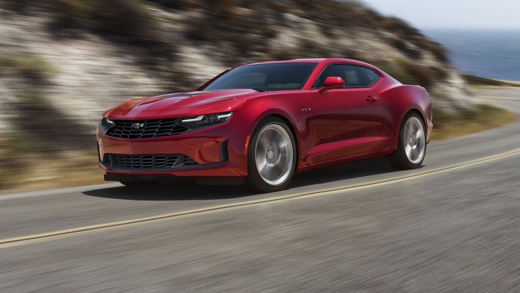 A red 2021 Chevy Camaro racing down the road