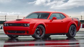 A red 2021 Dodge Challenger parked on the track