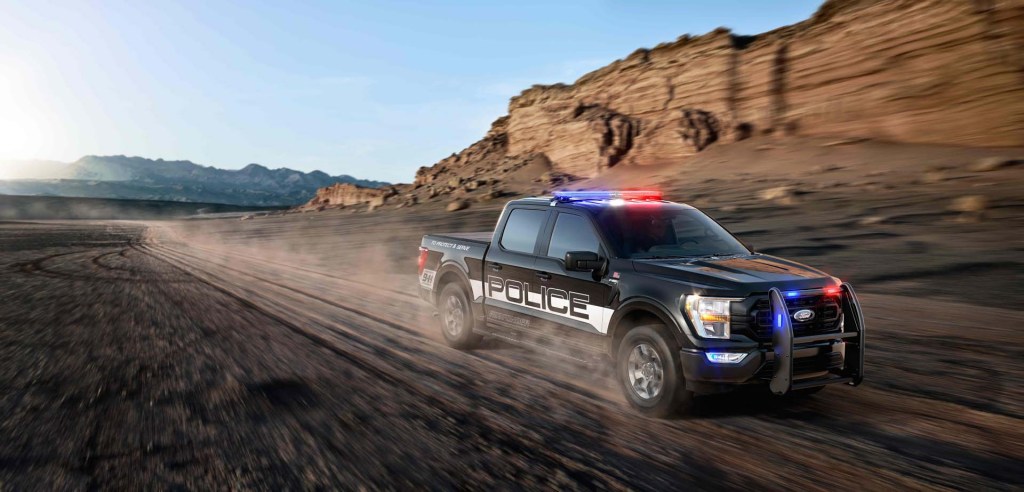 The 2021 Ford F-150 Police Responder racing down a dirt road 
