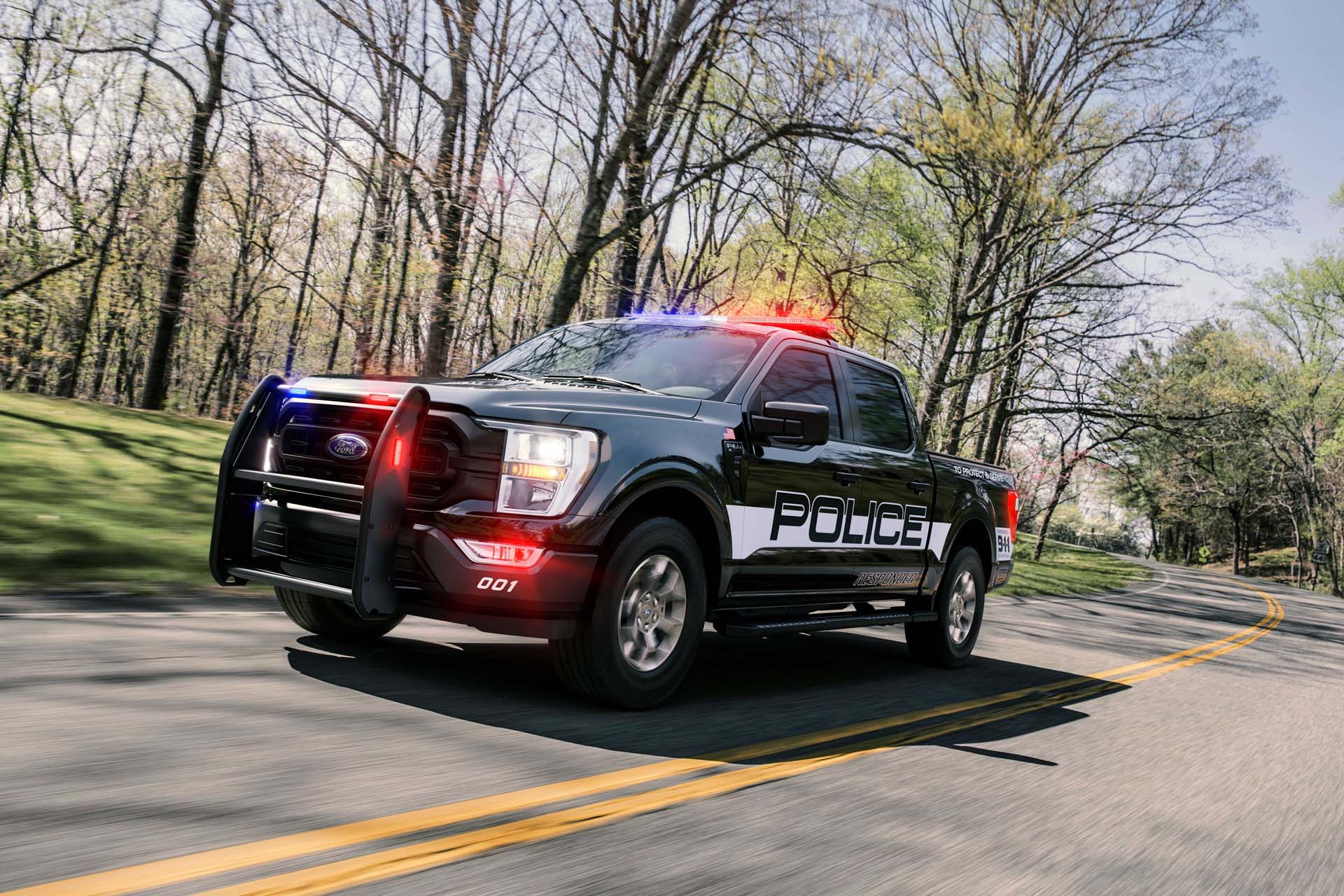 The 2021 Ford F-150 Police Responder racing down the road with its lights on
