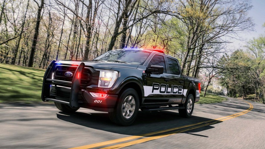 The 2021 Ford F-150 Police Responder racing down the road with its lights on