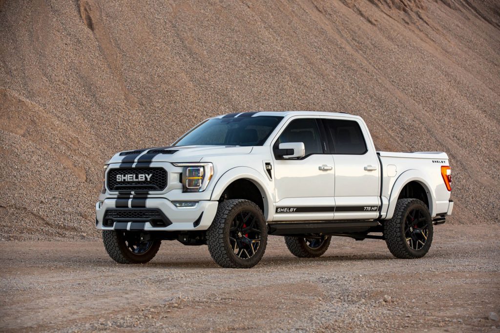 A white 2021 Ford F-150 Shelby parked in the sand