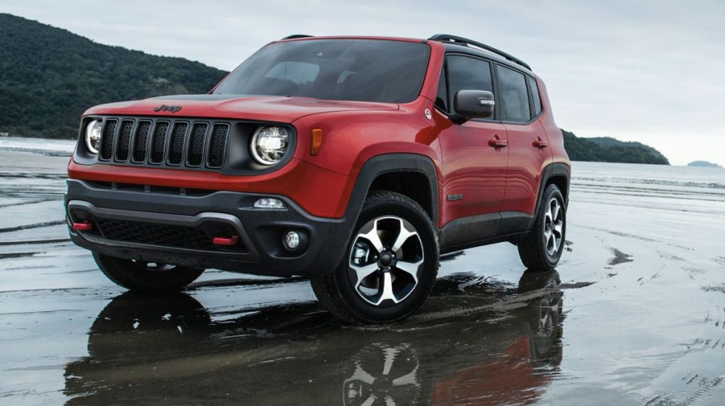 A red 2021 Jeep Renegade driving on a slick surface
