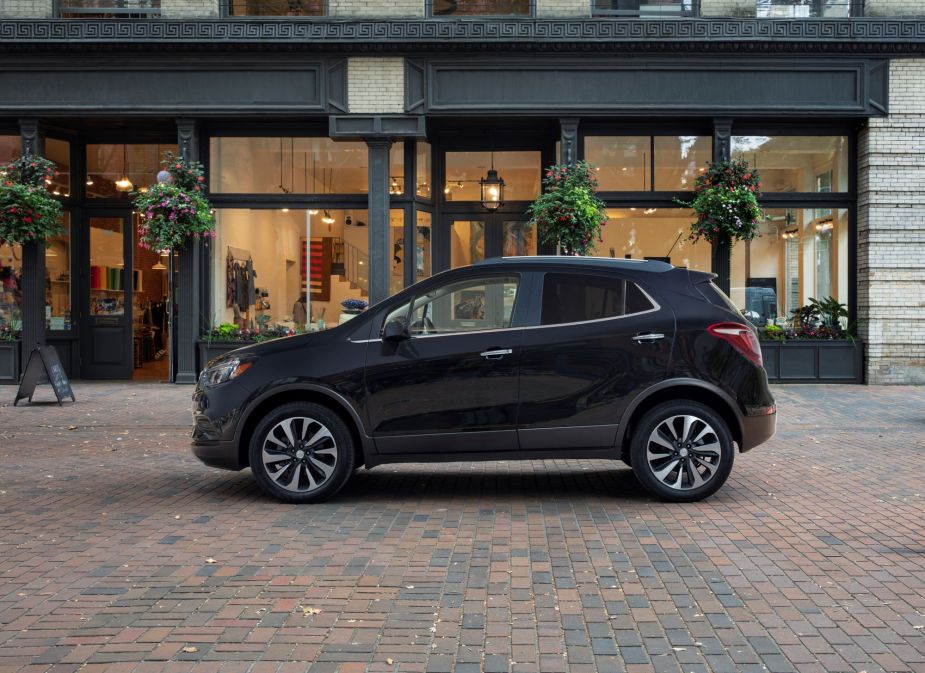 A 2022 Buick Encore compact SUV model parked near a store on a cobblestone road