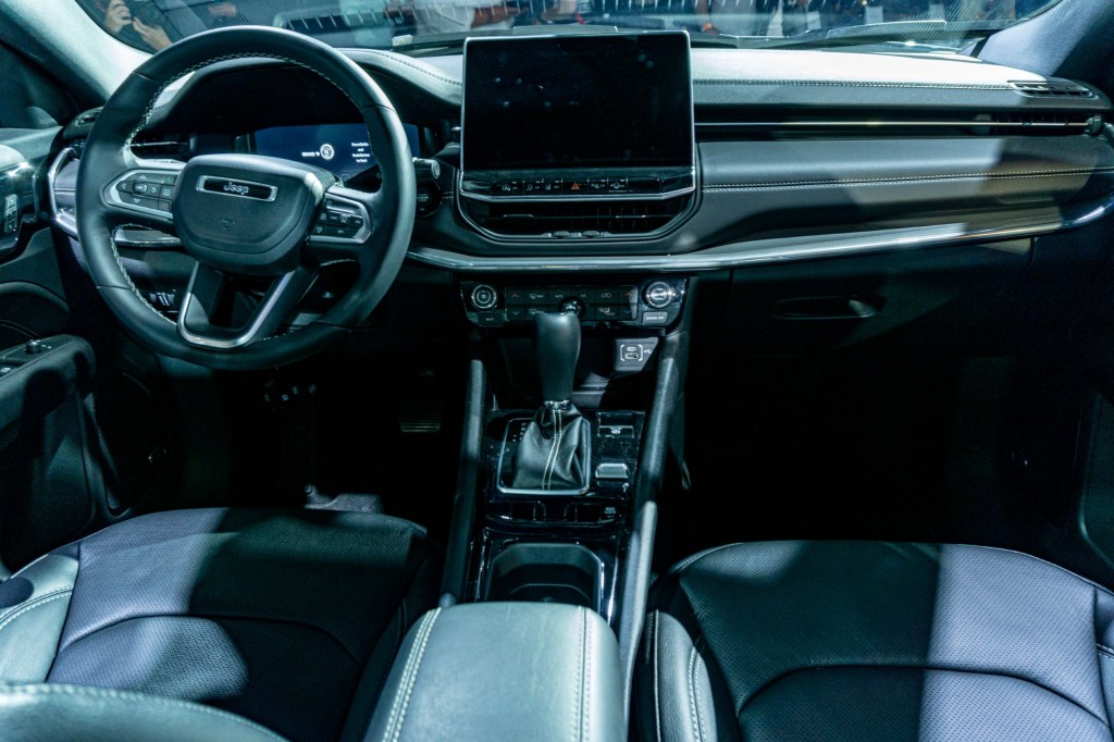 The black-leather-upholstered front seats and dashboard of the 2022 Jeep Compass Latitude LUX