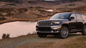 The 2022 Jeep Grand Cherokee L SUV model parked on a hill near a river