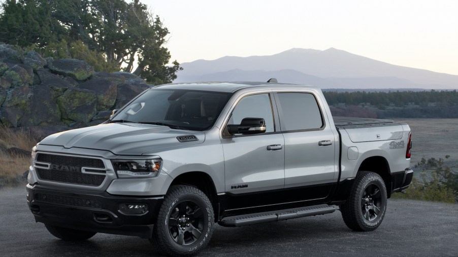 A 2022 Ram 1500 BackCountry pickup truck parked on asphalt in front of a plain and mountains