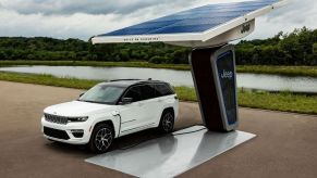 The 2022 Jeep Grand Cherokee 4xe charging at a trailhead