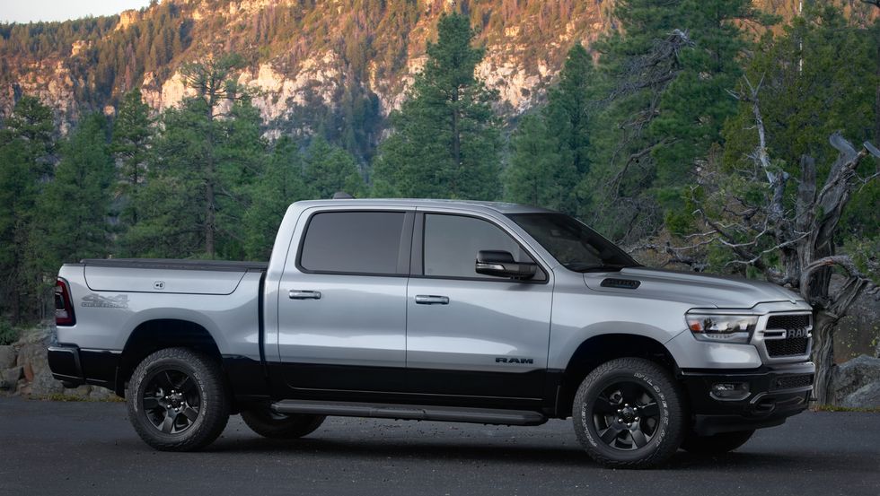 The 2022 Ram 1500 BackCountry Edition from the side and in front of trees 