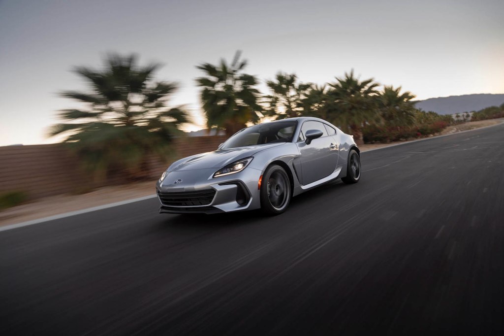 A silver 2022 Subaru BRZ driving, the BRZ is an affordable sports car under $40,000
