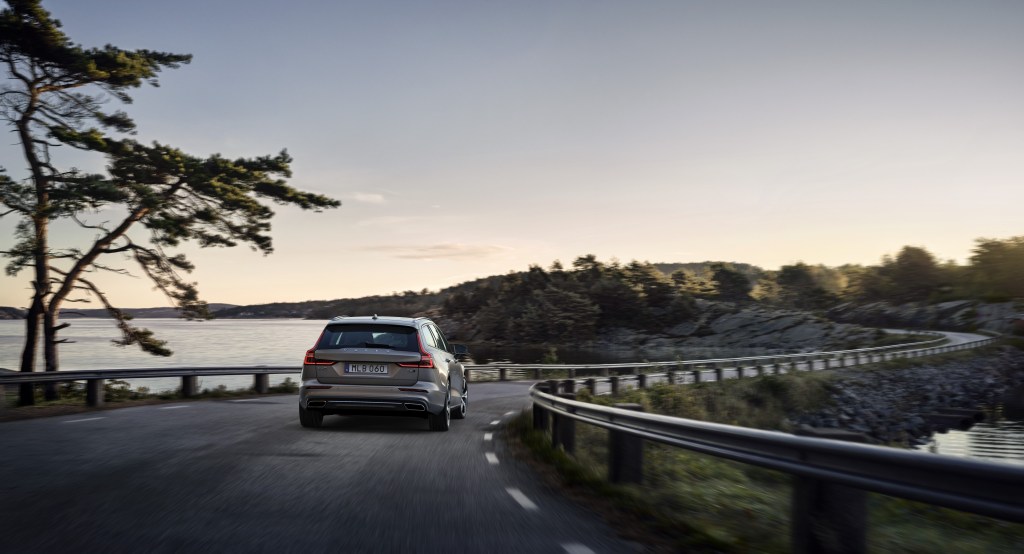 A grey Volvo V60 driving down a winding road