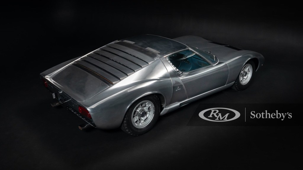 The rear of the bare metal Miura, shot in a black photobooth