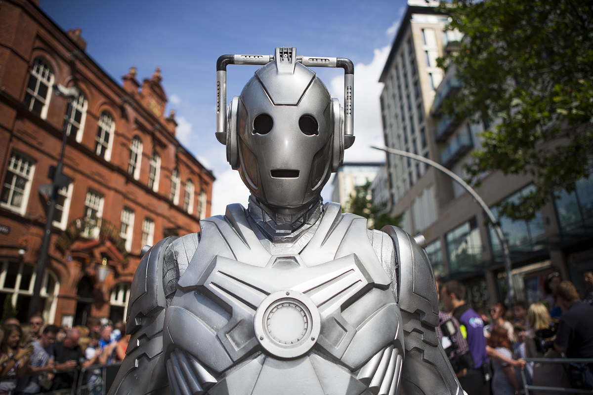 A silver cyborg in a crowd. The Tesla Cybertruck and Doctor Who Cybermen are eerily similar.