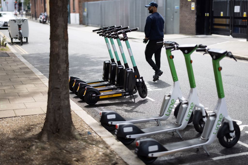 A line of Lime and Tier electric motorized scooters in London, England