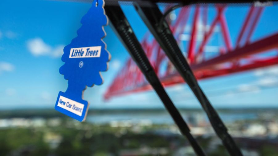 A blue Little Trees air freshener hanging within a crane in Portland