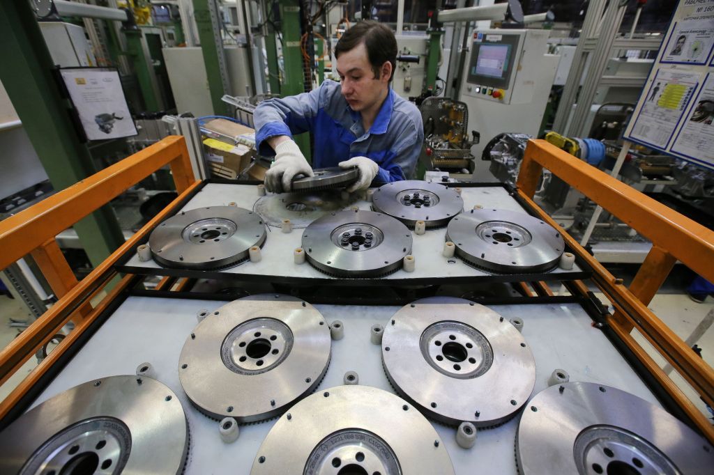 A Russian worker arranges AvtoVAZ clutch flywheels at the company's factory in Togliatti, Russia