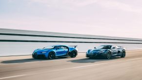 A blue-and-black Bugatti Chiron Sport and a black Rimac Nevera speed around a racetrack