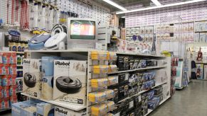 Robot vacuum cleaners on a merchandise display in a Bed Bath & Beyond