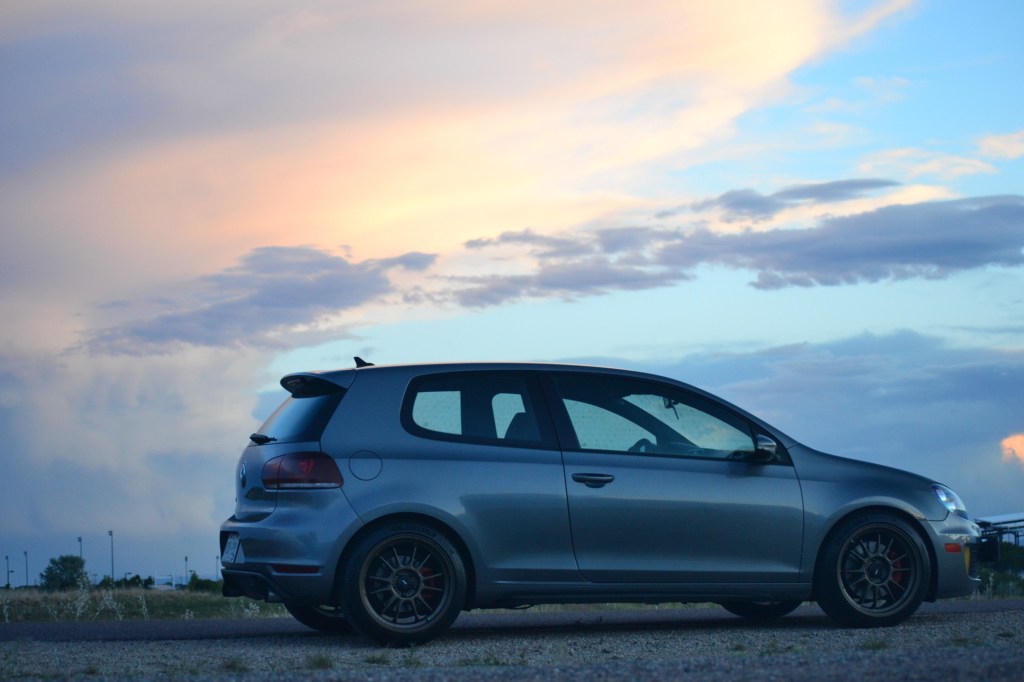 A gray Volkswagen GTI at sunset photographed in profile.