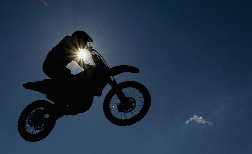 A silhoutte of a motorbike is seen during the Moto Cross side car World Cup Final. Triumph is getting into motocross and enduro 