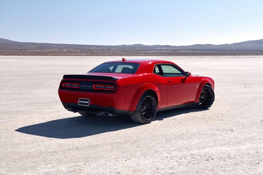 A red Dodge Challenger parked in the desert, the Dodge Challenger is one of the fastest cars under $30K