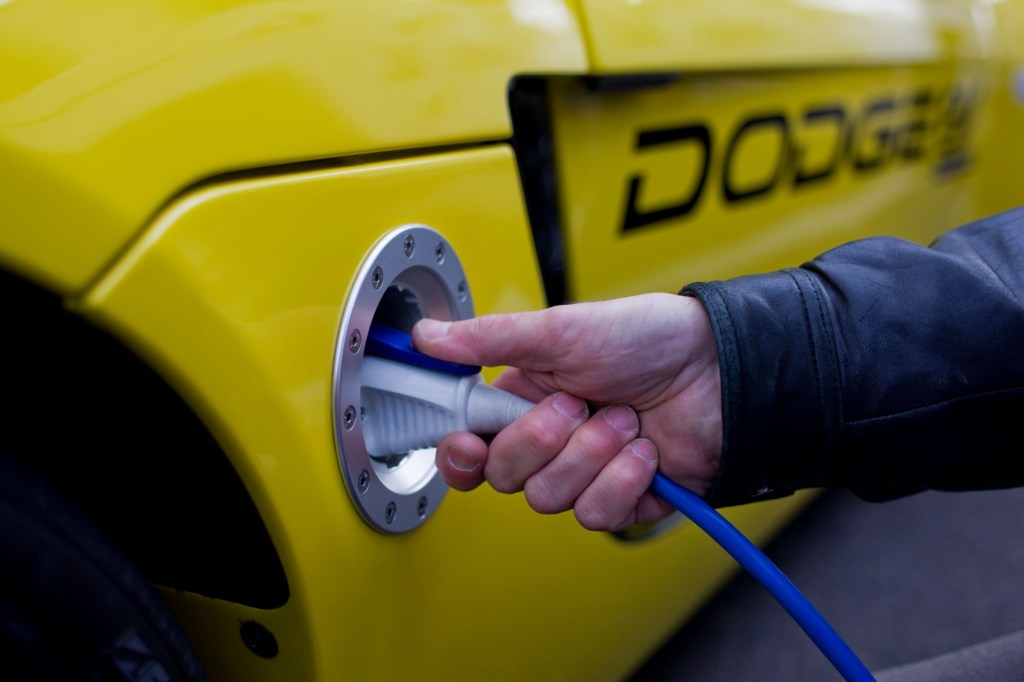 A charging cord plugged into a Dodge EV concept model