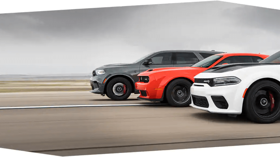 A gray Dodge Durango, an orange Dodge Challenger, and a white Dodge Charger