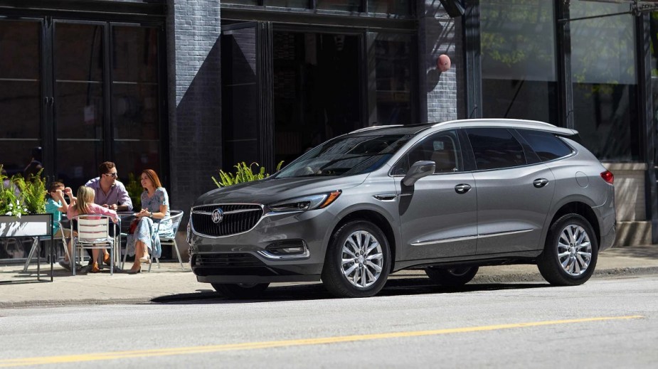 A silver 2021 Buick Enclave parked on the side of a street.