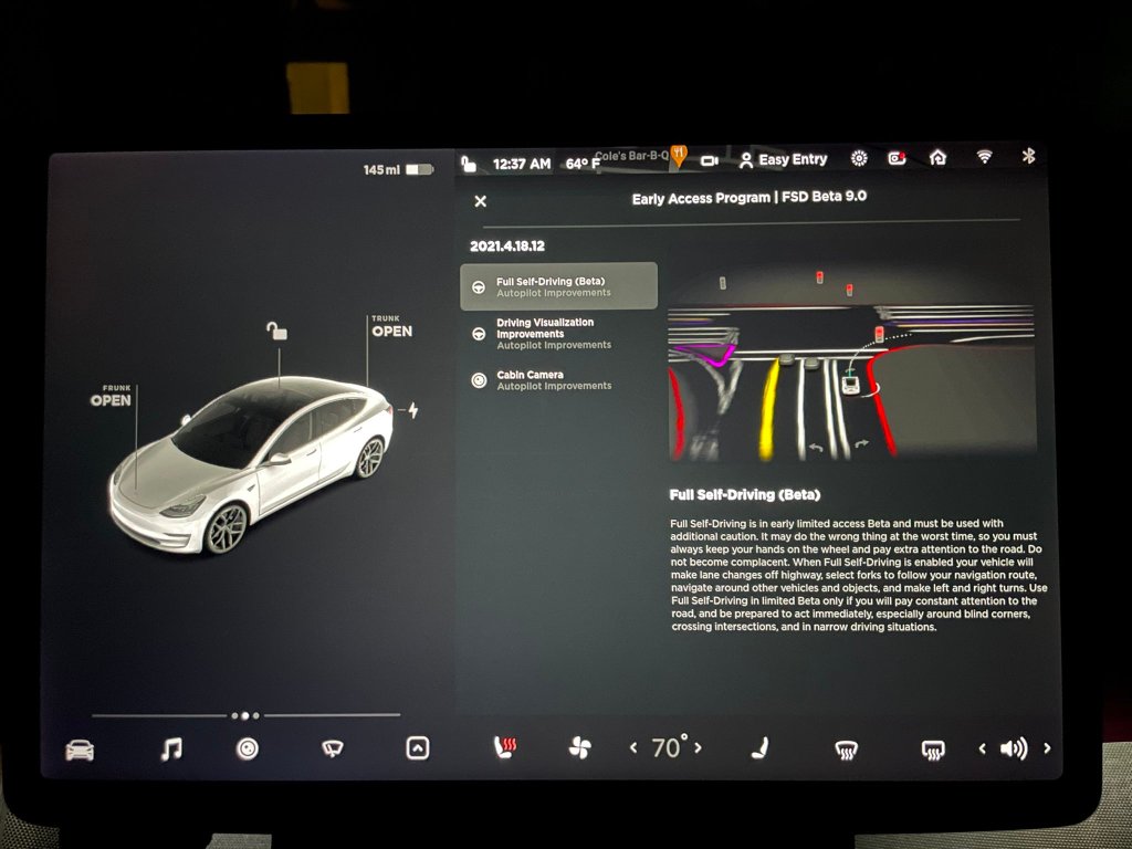 A photo via Twitter user @tesla_raj showing the center display of a Tesla and the text "Full Self-Driving" (Beta)" with a warning that says "...it may do the wrong thing at the worst time."