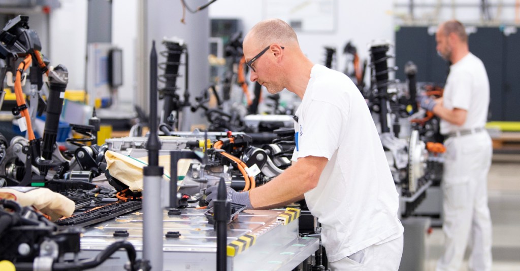  Volkswagen employees wire the battery on a line for the VW ID.3 during a press tour of Volkswagen's Transparent Factory. 35 all-electric vehicles are produced daily at the Dresden site. 