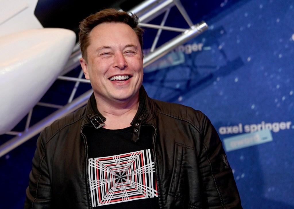 Elon Musk in front of a blue and white background. Morgan Stanley thinks Tesla electric aircraft will be a thing one day.