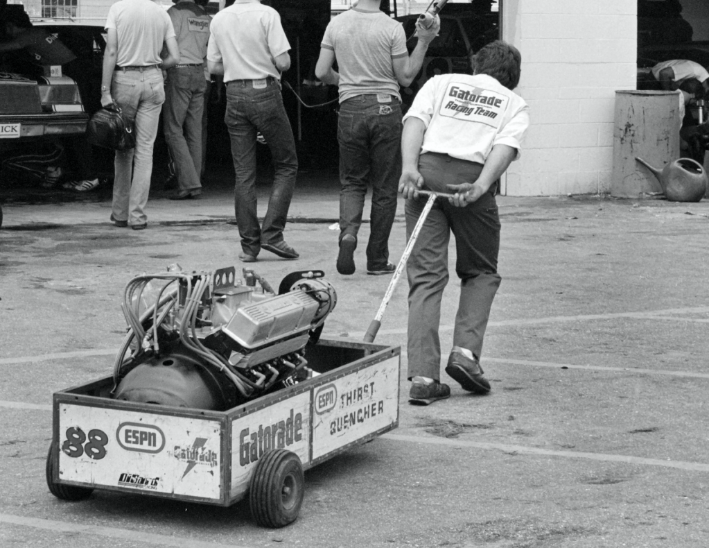 man hauling an engine in a cart