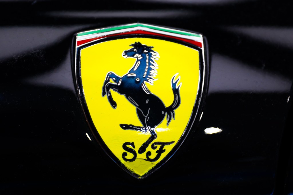 A yellow Ferrari emblem on a black supercar on June 28, 2021