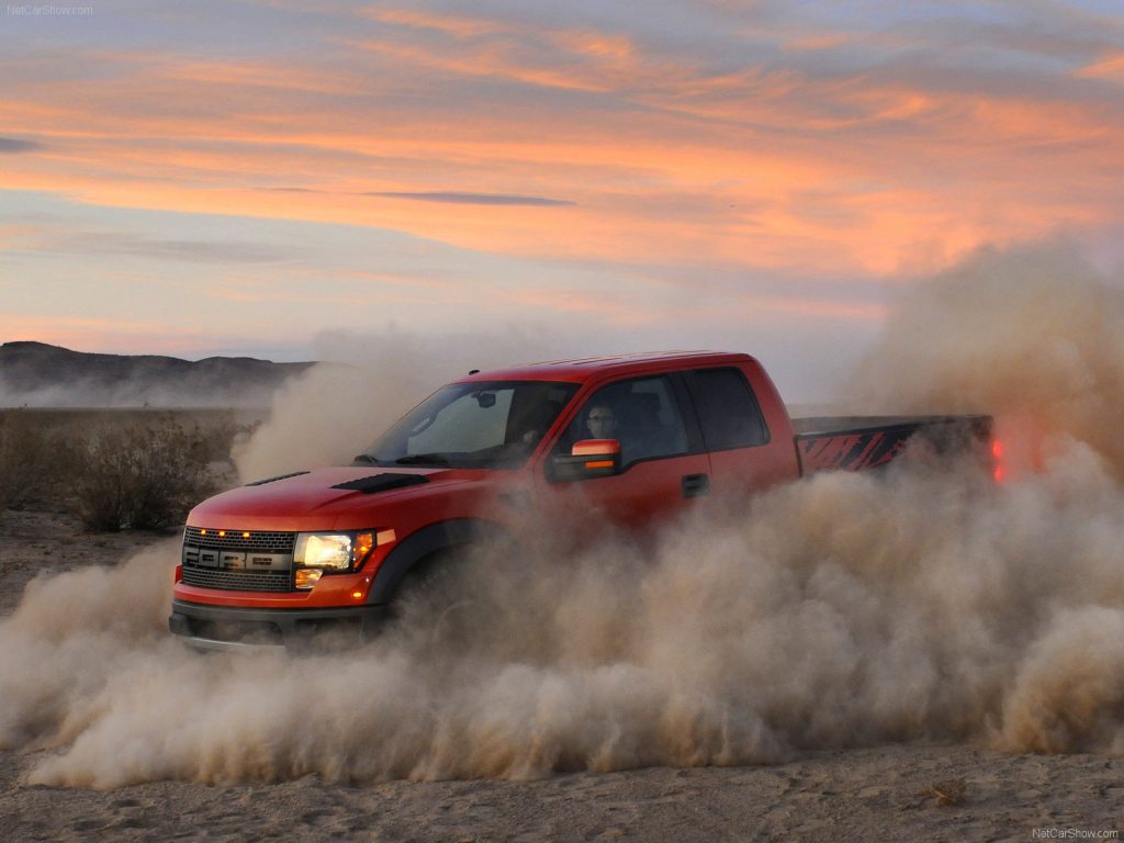 The Raptor slides around in the sand at sunset