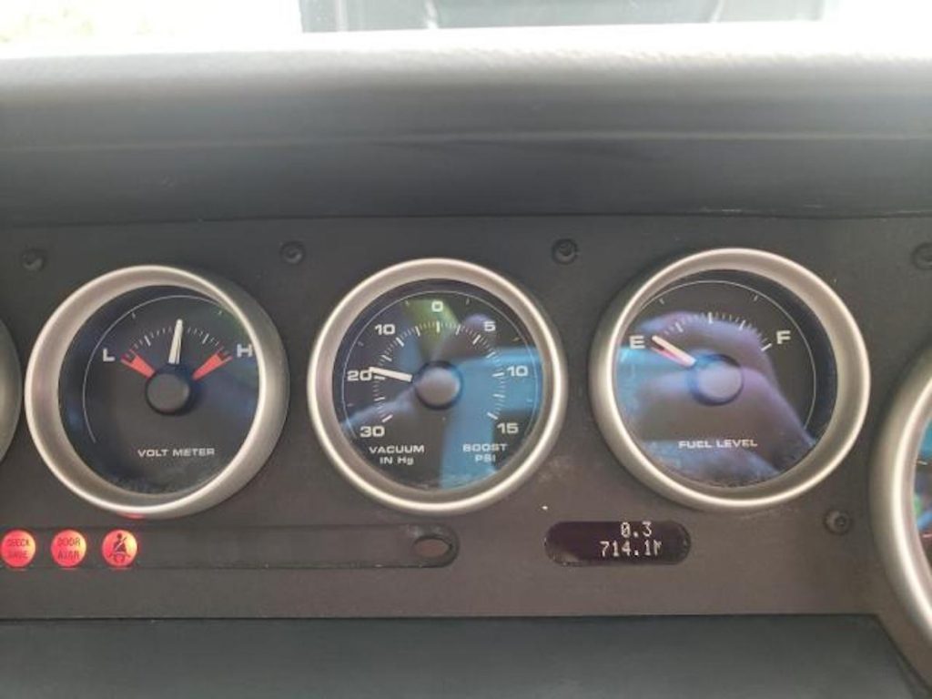 2006 Ford GT dashboard with "714" miles on the readout
