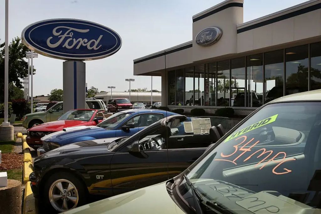 String of Ford vehicles sitting on a new car dealership lot