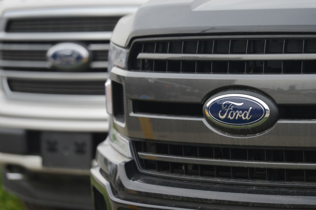 Ford logos on the grilles of two pickup trucks