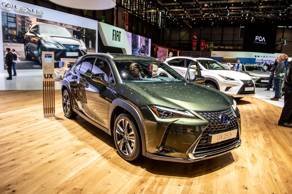 a green 2019 Lexus UX on display at an indoor auto show