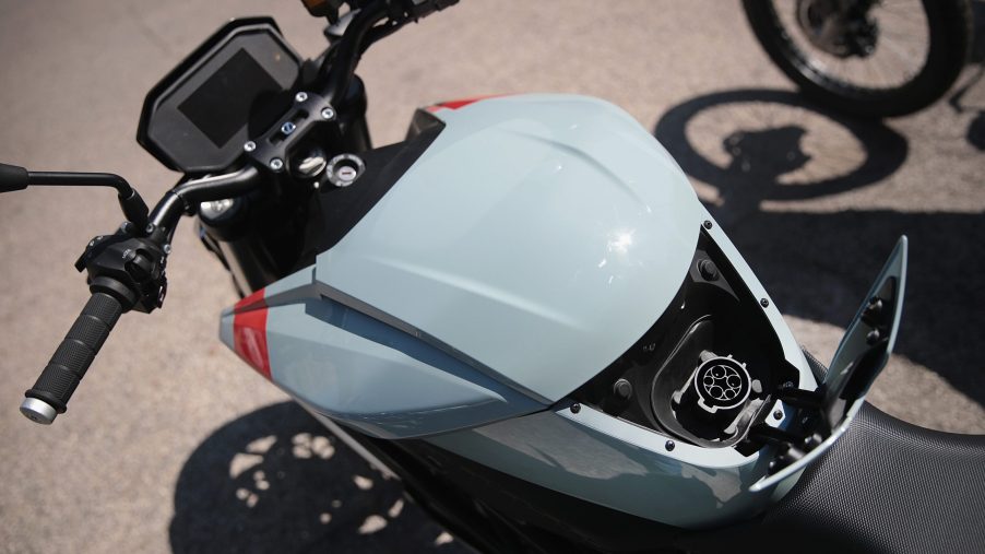 The charging port on an electric motorcycle, right where the gas tank would be