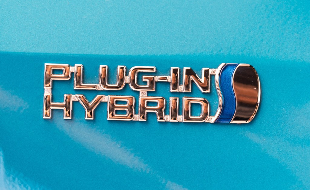 A silver Plug-In Hybrid Electric Vehicle (PHEV) badge