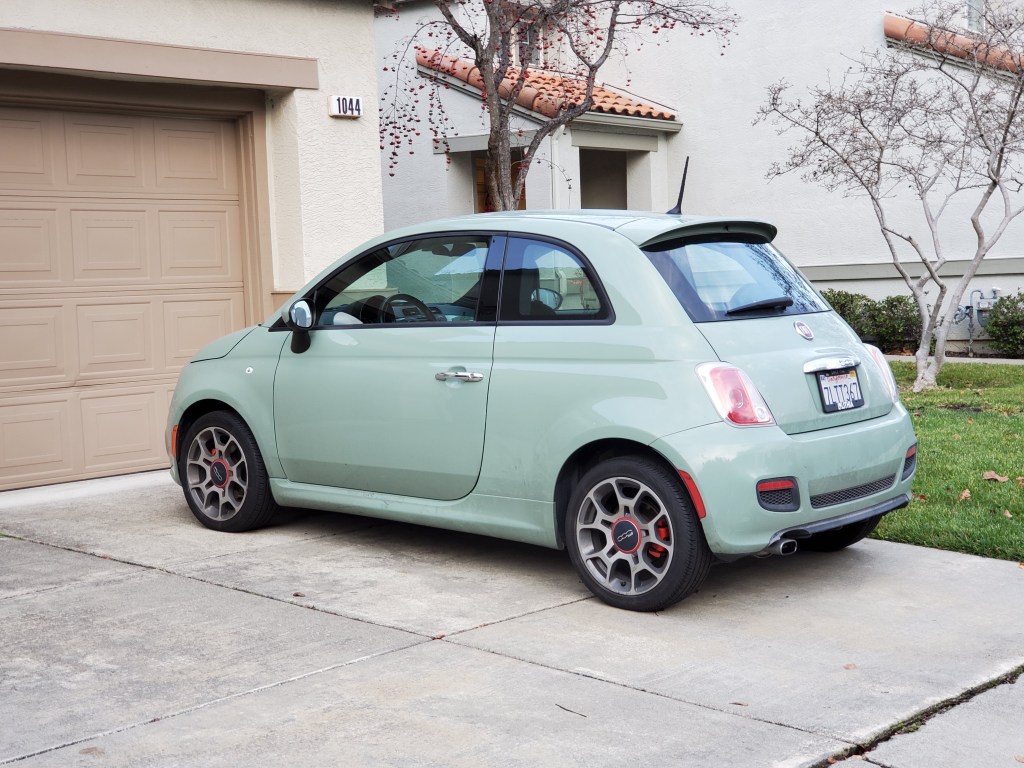 a mint green 2019 Fiat 500 parked in a driveway 