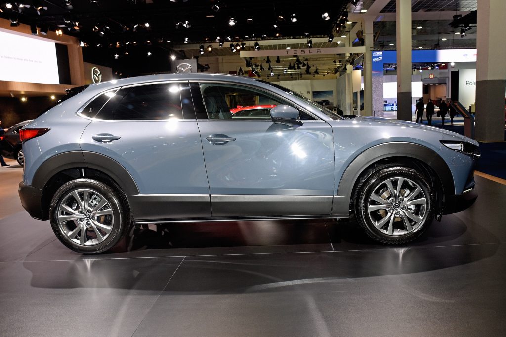 a side view of a light blue 2021 Mazda CX-30 on display at an indoor auto show